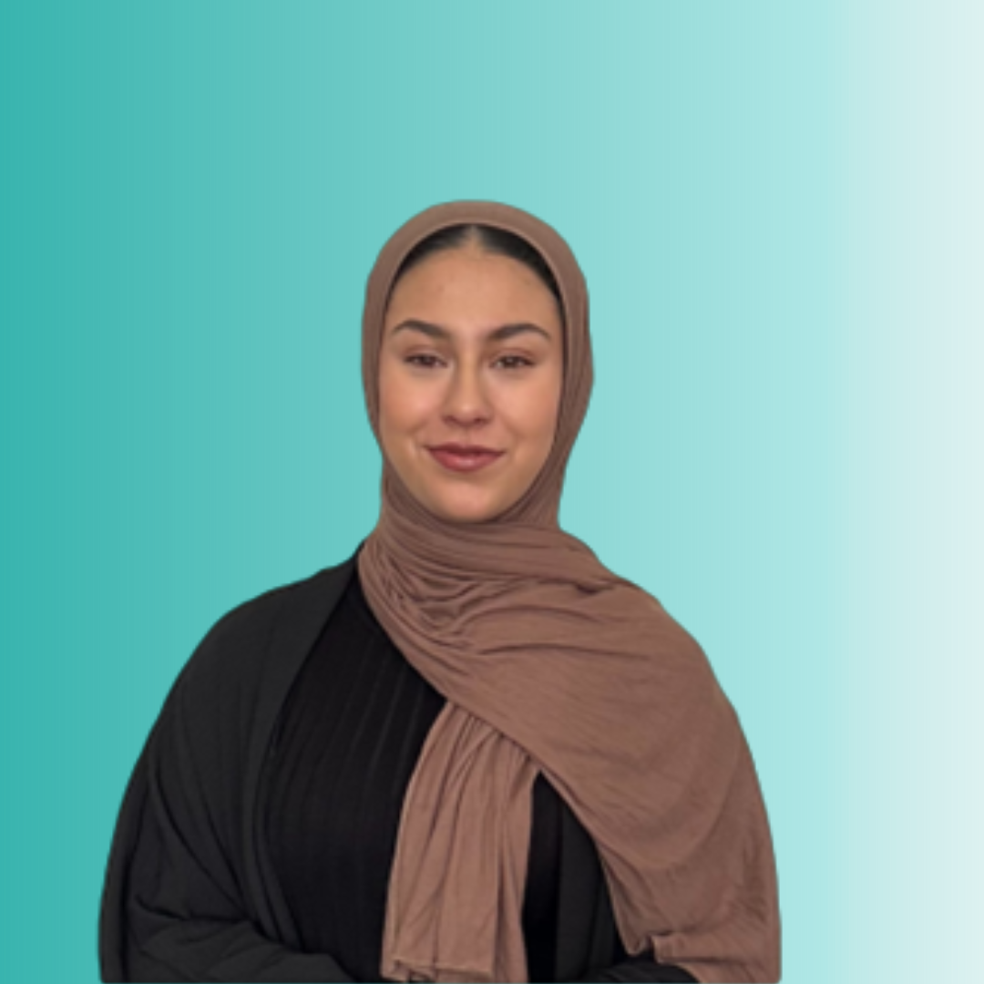 A woman in a hijab stands confidently against a solid blue background. There is a link to a web page on this website.