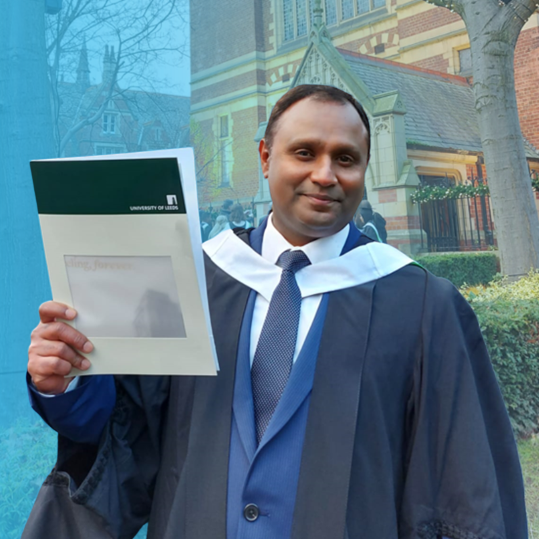 A man in a graduation gown proudly holds his diploma, celebrating his academic achievement. There is a blue tint too the background. There is a link to a web page on this website.