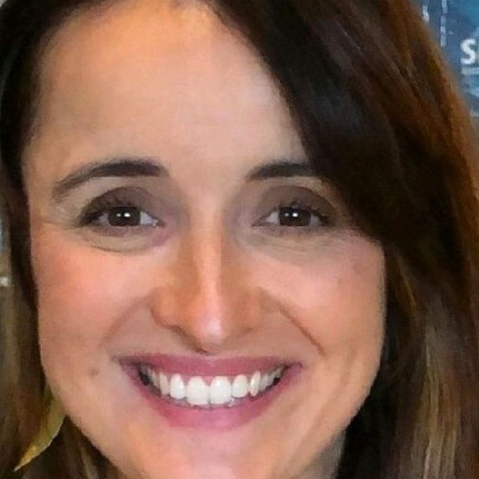 A close-up image of a person with long brown hair.