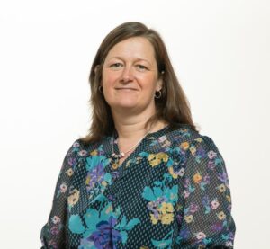 Chief Executive Dr Sara Munro facing camera