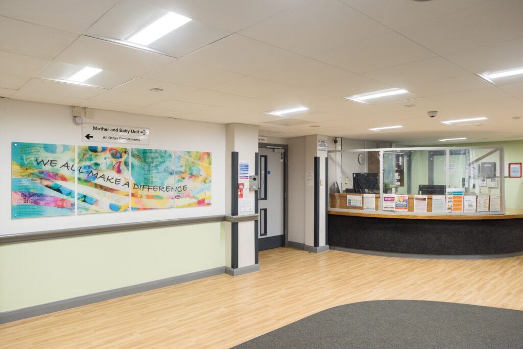 A picture of the reception area at The Mount including an artwork display which says "we all make a difference."
