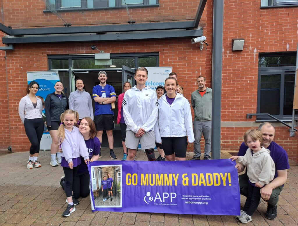 A group shot including Rachel Lucas, her partner James and staff from our mother and baby unit