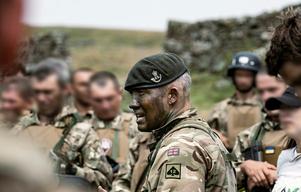 A senior officer of the 3 rifles giving a briefing in the field.