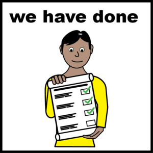 A person holding a completed checklist with several green tick marks.
